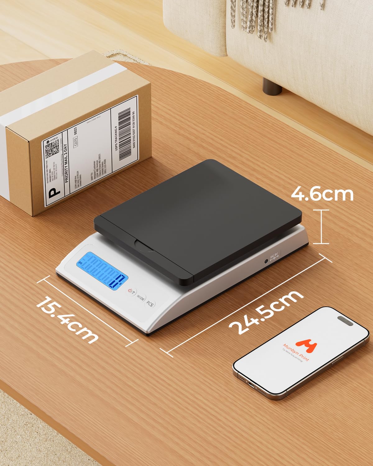 Black MUNBYN IPS01 postal scale used with label printer accessories, showing the device with digital display and compact design.
