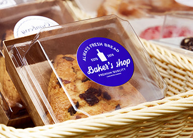 Packaged cookies with a 'Baker's shop' label on a woven basket