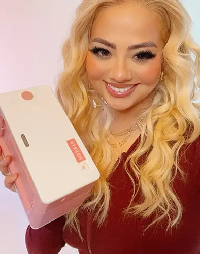 Woman holding a pink thermal printer from MUNBYN